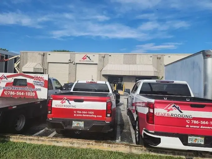 4ever Roofing branded trucks parked in front of the company warehouse in Hialeah